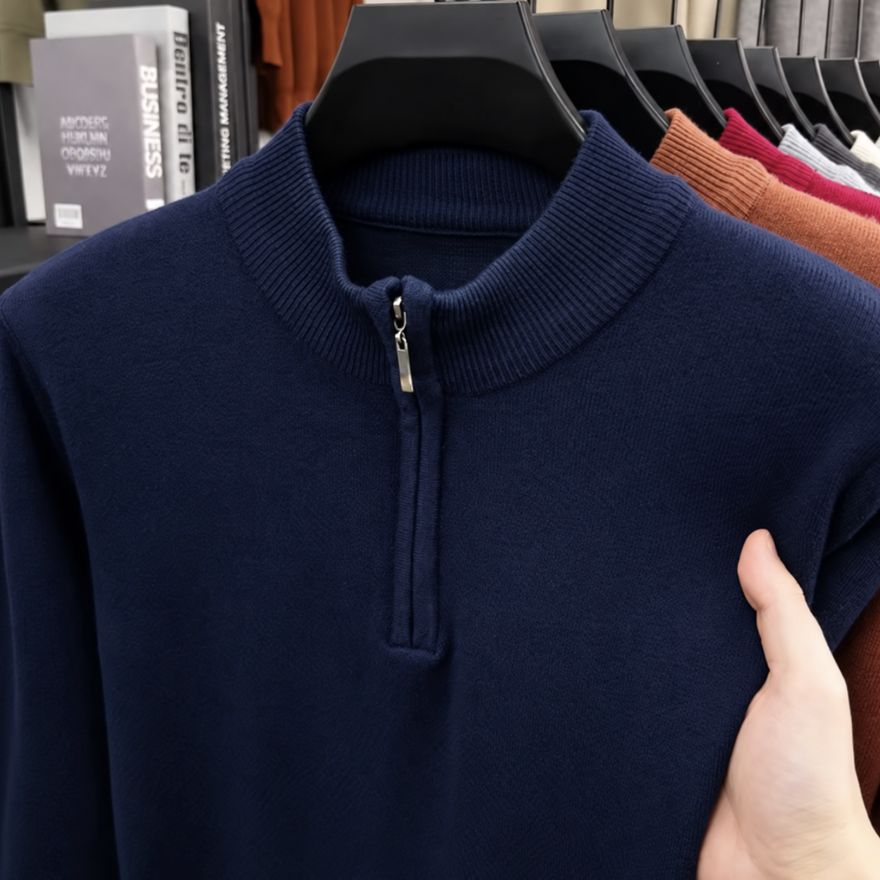 Raw supplier photograph of a navy quarter-zip sweater on a hanger
